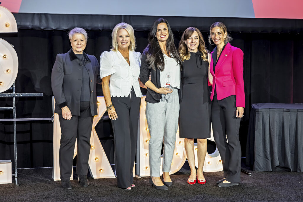 Tabitha holding her award onstage at the 2026 Wendy's Wonderful Kids summit, alongside Foundation Staff.